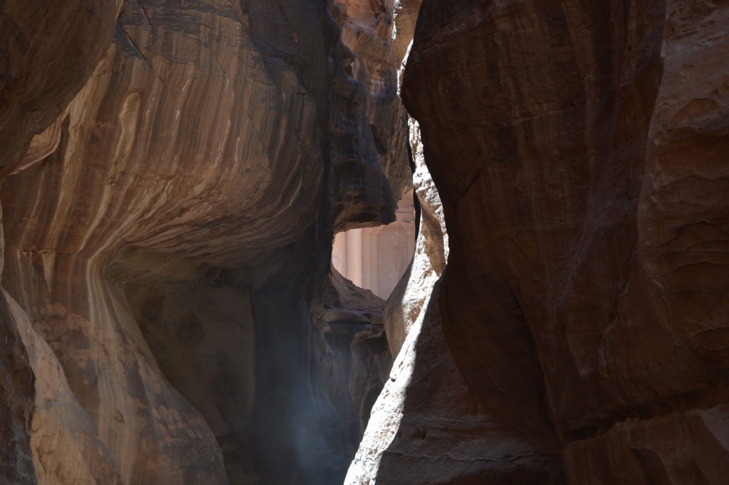 A gap in the rocks of the Siq gives a glimpse of the Treasury: the best preserved and most dramatic of Petra's tombs.